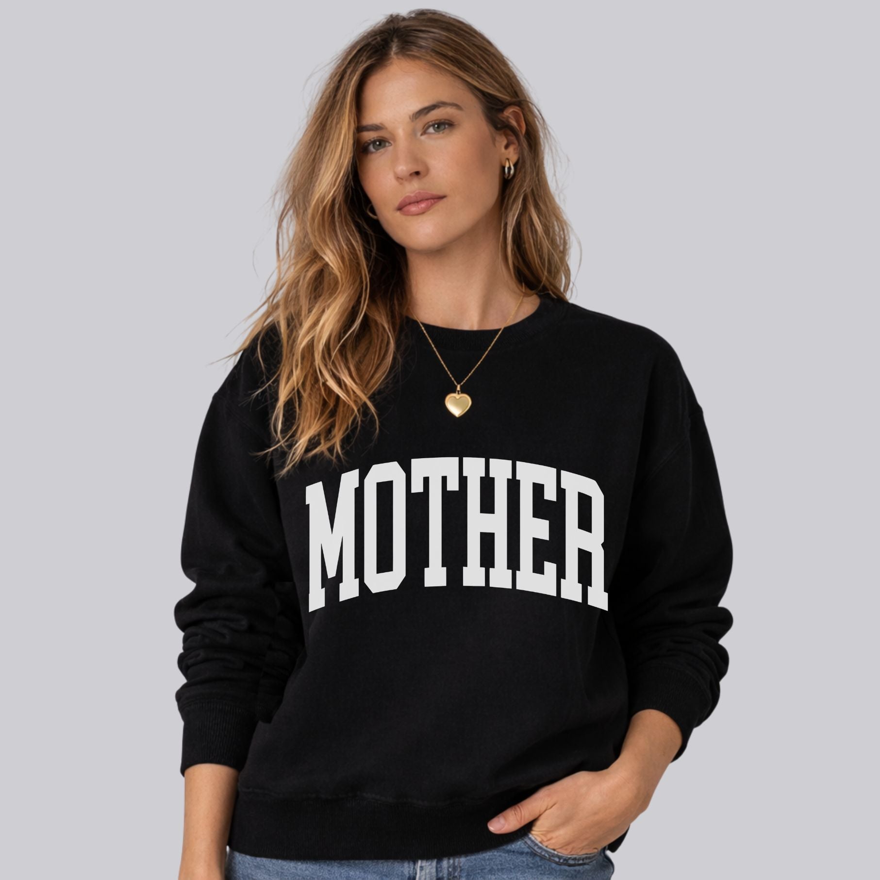 Woman wearing preppy black Mother sweatshirt with collegiate white text