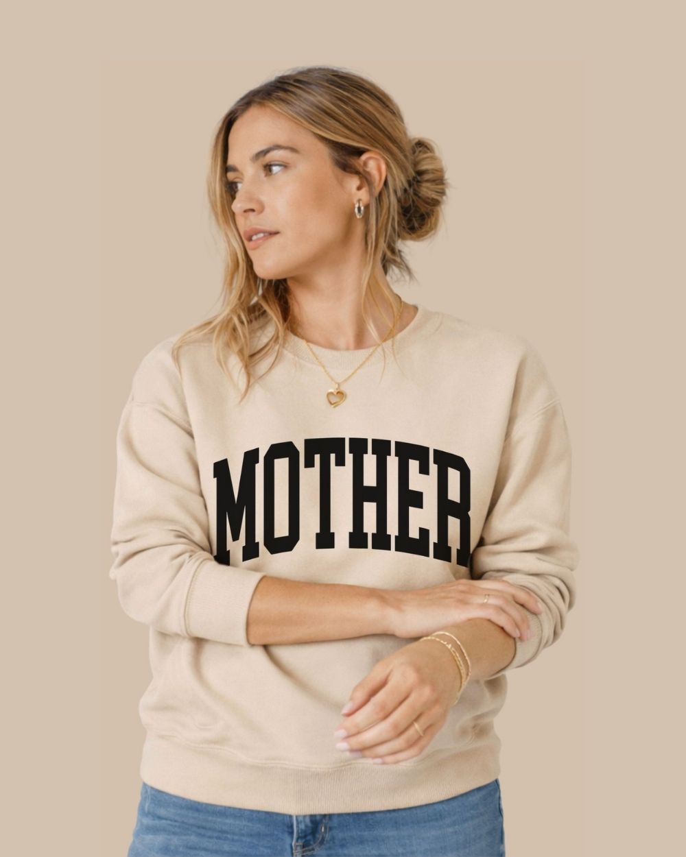 Woman wearing preppy sand Mother sweatshirt with collegiate white text