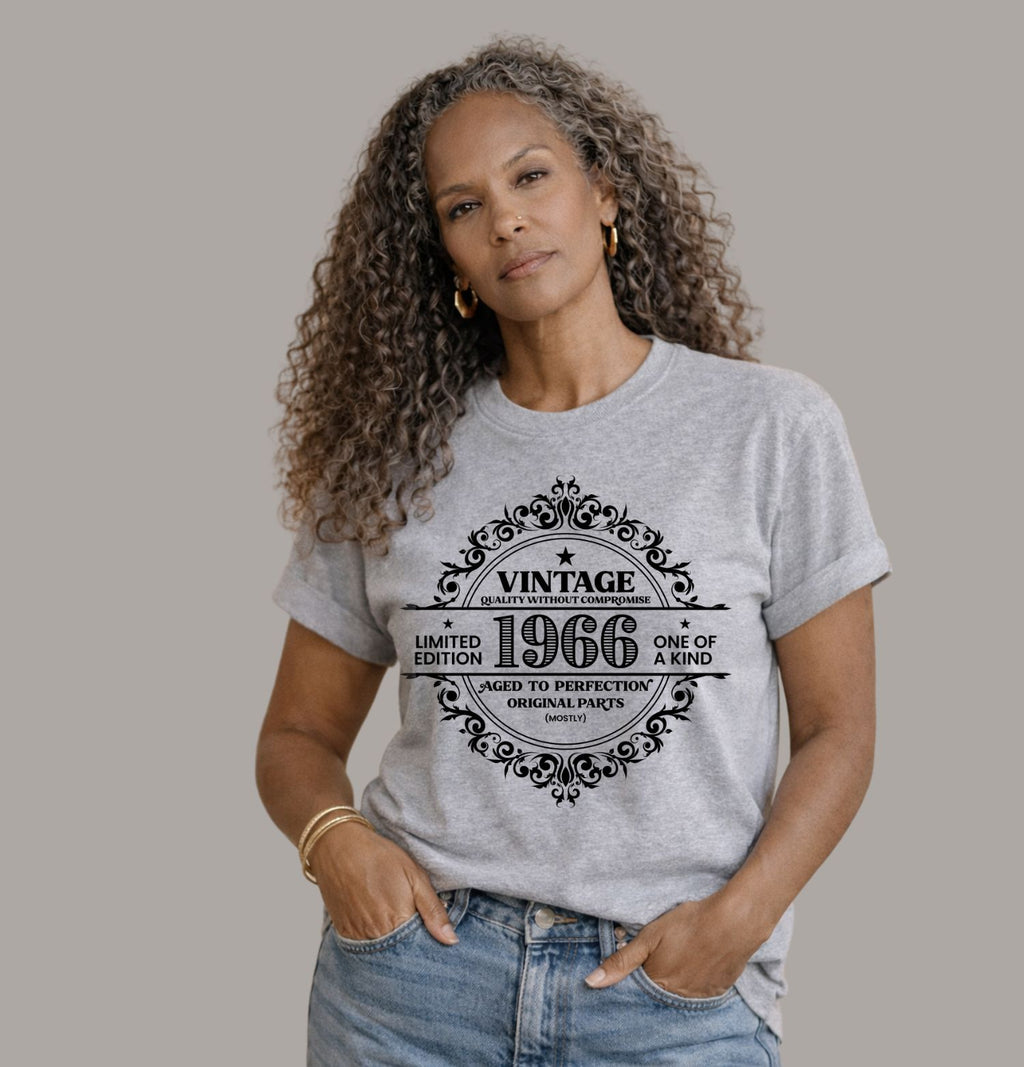 Vintage 1966 limited edition birthday shirt on a athletic heather Bella Canvas t-shirt worn with blue jeans and cardigan