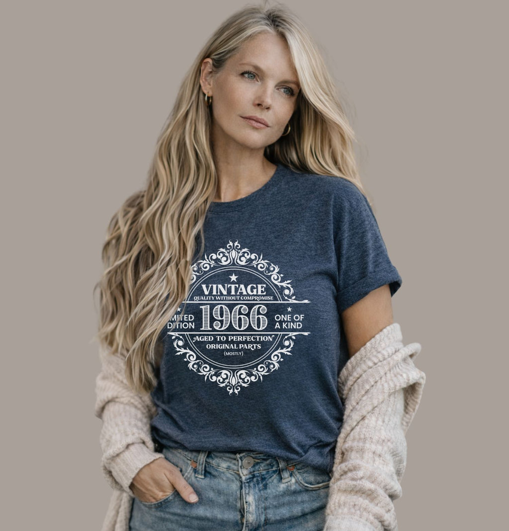 Vintage 1966 limited edition birthday shirt on a heather navy Bella Canvas t-shirt worn with blue jeans and cardigan