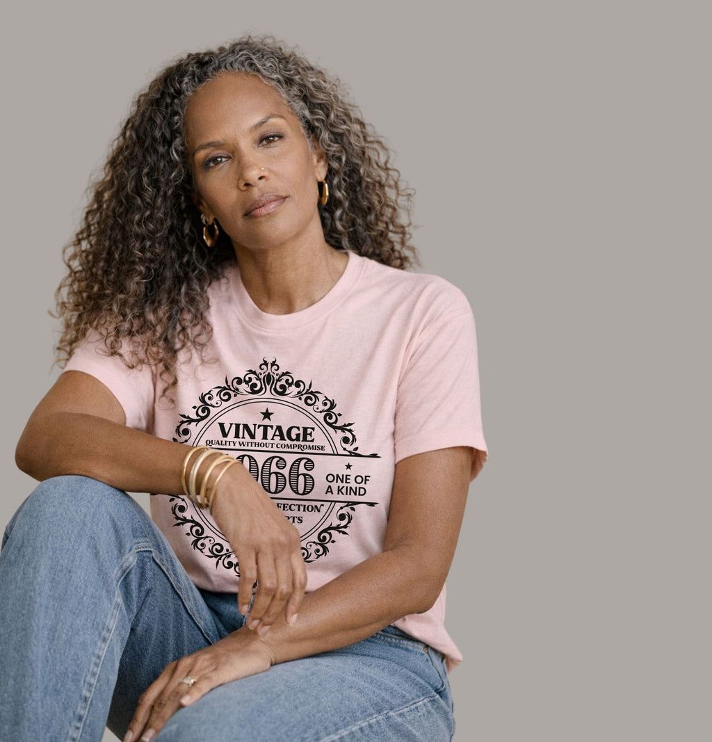 Vintage 1966 limited edition birthday shirt on a soft pink Bella Canvas t-shirt worn with blue jeans and cardigan