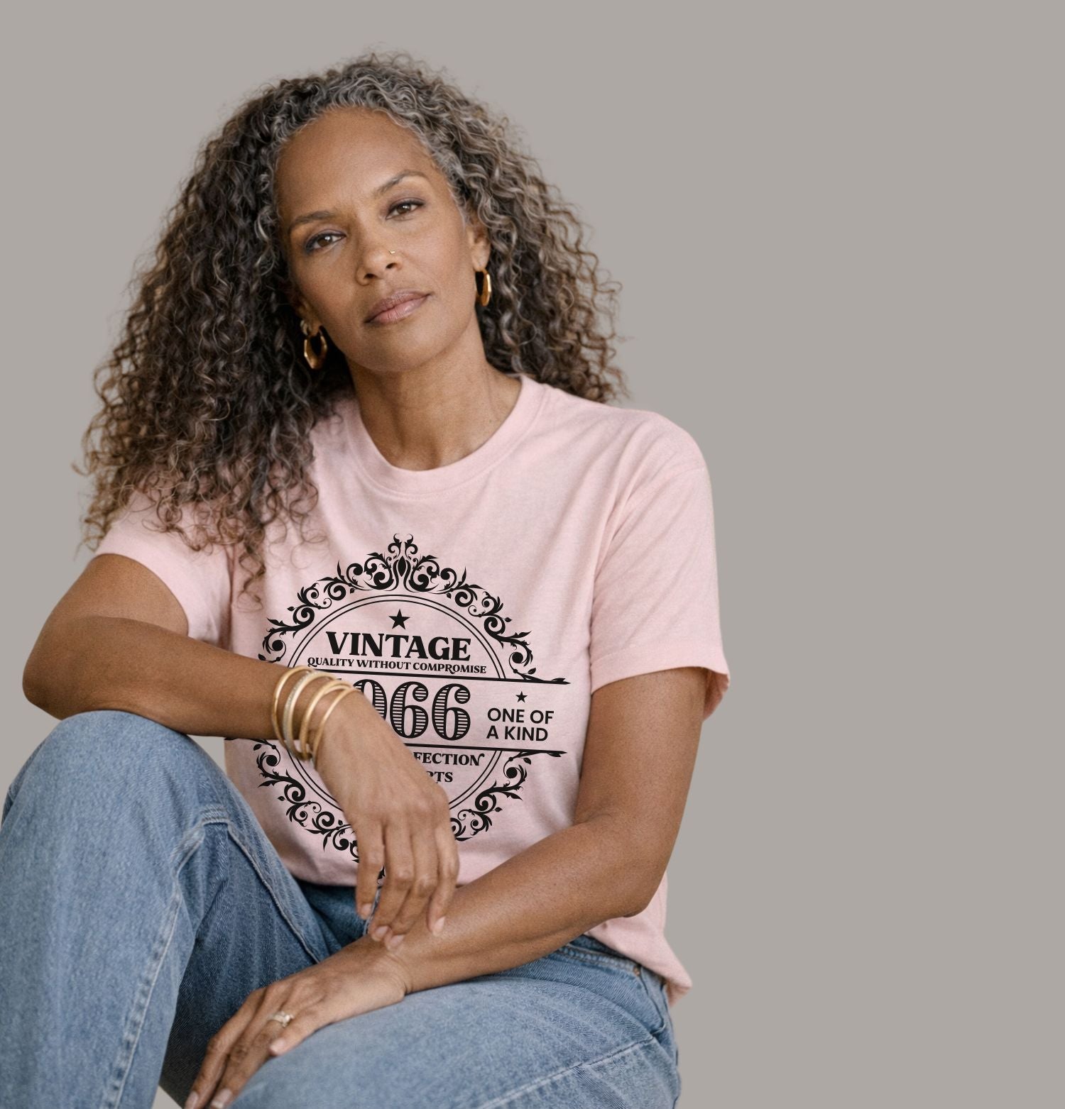 Vintage 1966 limited edition birthday shirt on a soft pink Bella Canvas t-shirt worn with blue jeans and cardigan