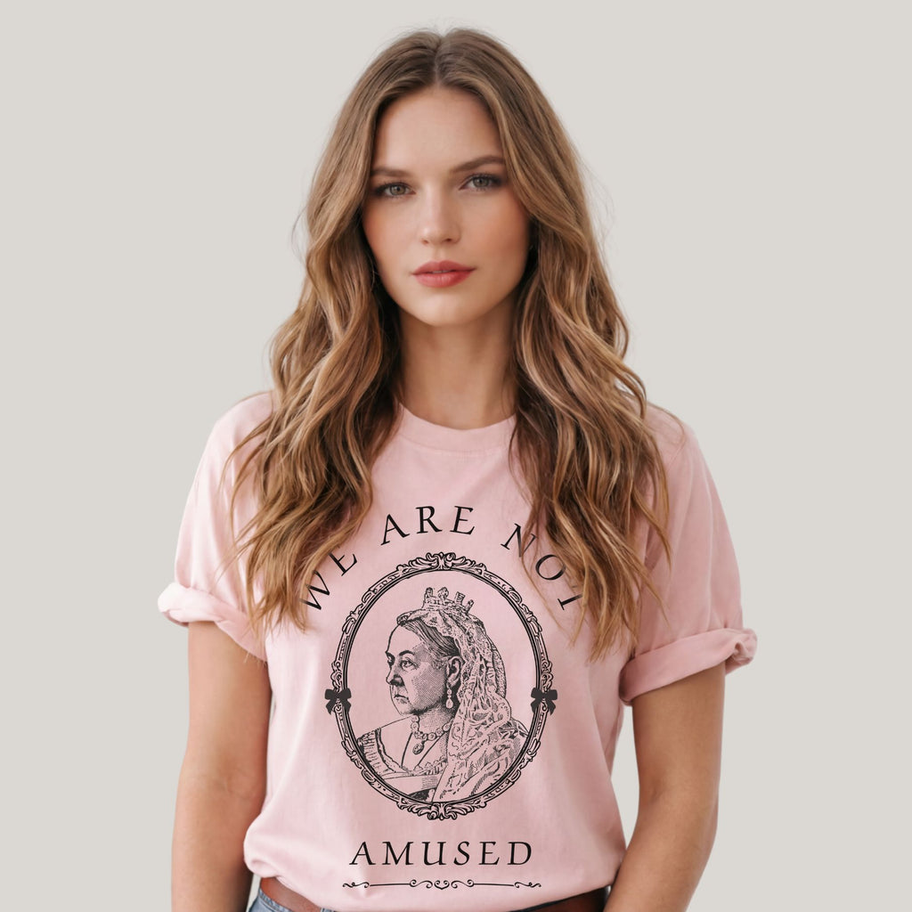 We Are Not Amused Queen Victoria quote shirt in soft pink worn by female model